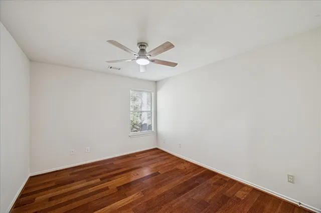 a bathroom with a double vanity sink a toilet a mirror and shower