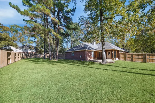 a view of a house with a yard patio and a yard