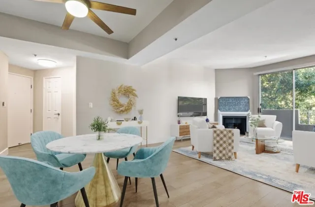 a dining room with furniture a fireplace and wooden floor