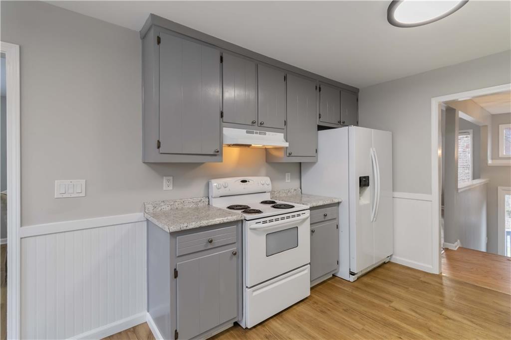 65 Hinton Court Dacula, GA 30019 - Photo 13 of 40 a kitchen with a stove a refrigerator and a sink