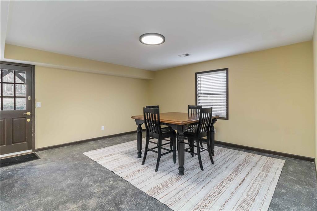 65 Hinton Court Dacula, GA 30019 - Photo 31 of 40 a view of a dining room with furniture and wooden floor