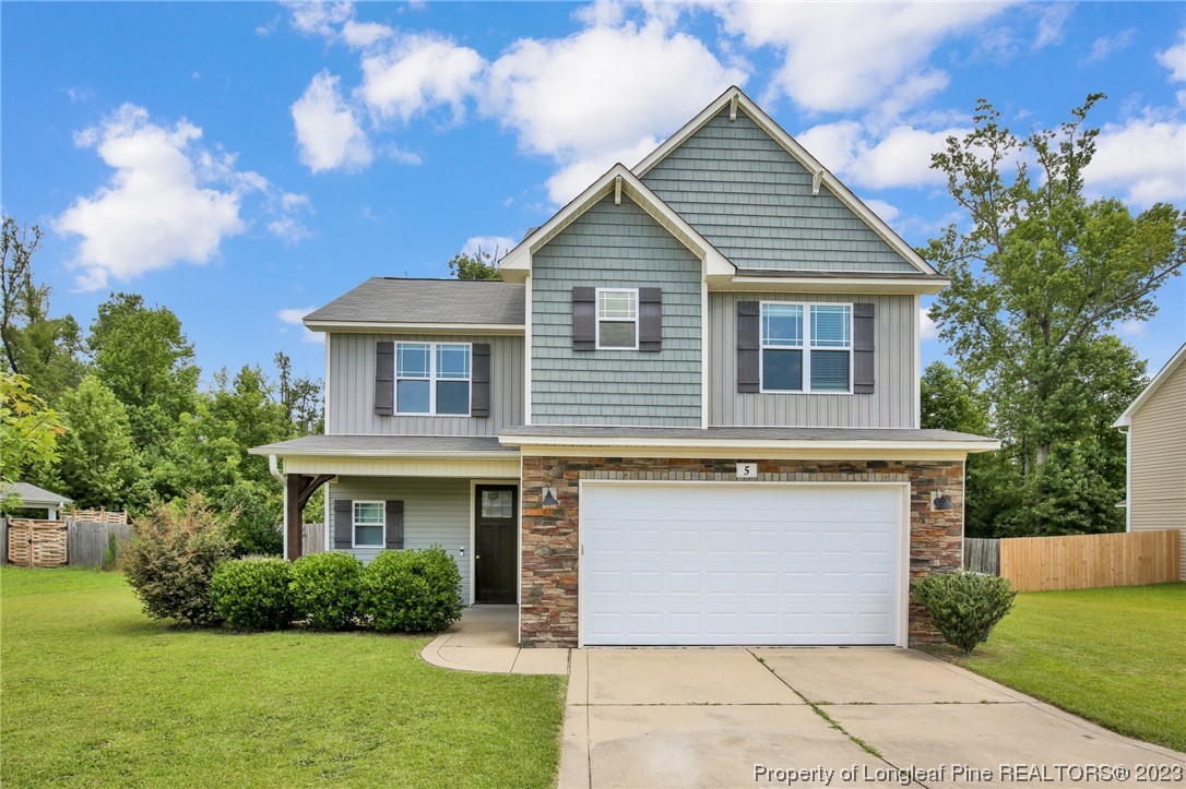 159 Boswell Street Raeford, NC 28376 - Photo 1 of 34 a front view of a house with a yard and garage