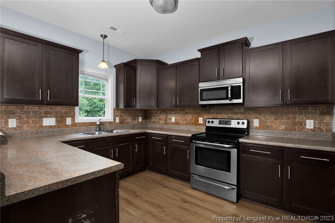 159 Boswell Street Raeford, NC 28376 - Photo 11 of 34 a kitchen with a sink stove and microwave