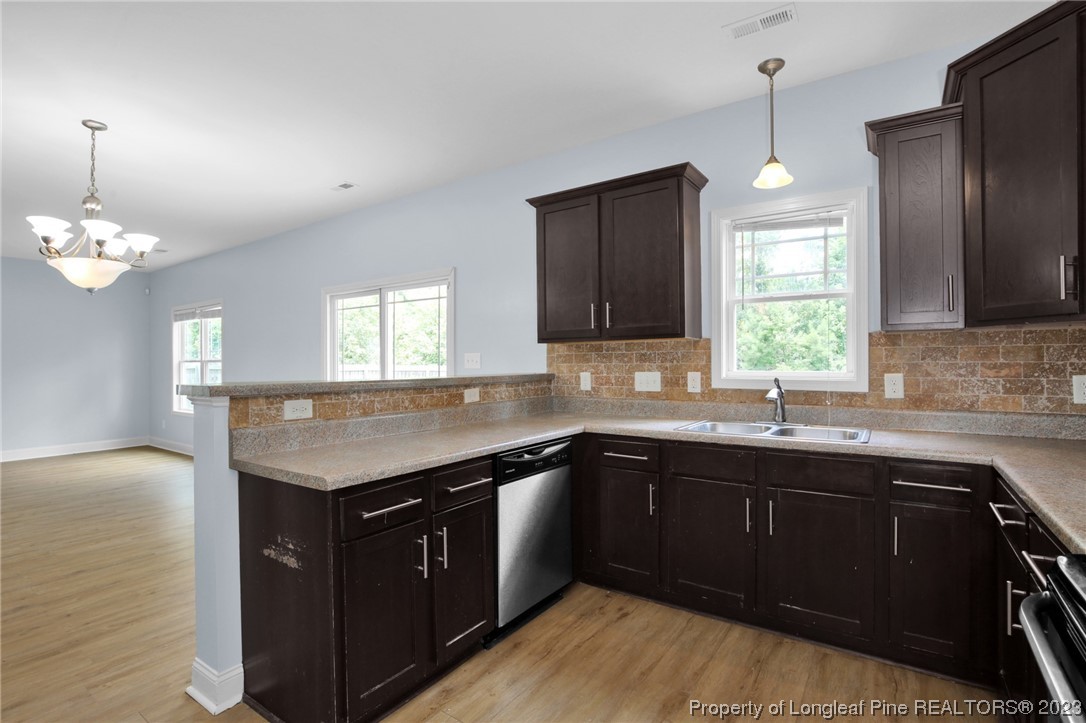 159 Boswell Street Raeford, NC 28376 - Photo 13 of 34 a kitchen with a sink stove and cabinets
