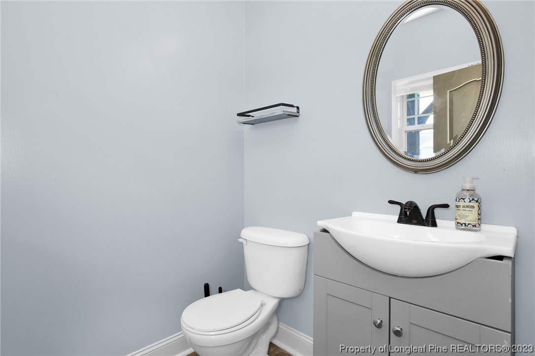 159 Boswell Street Raeford, NC 28376 - Photo 15 of 34 a bathroom with a toilet a sink and a mirror