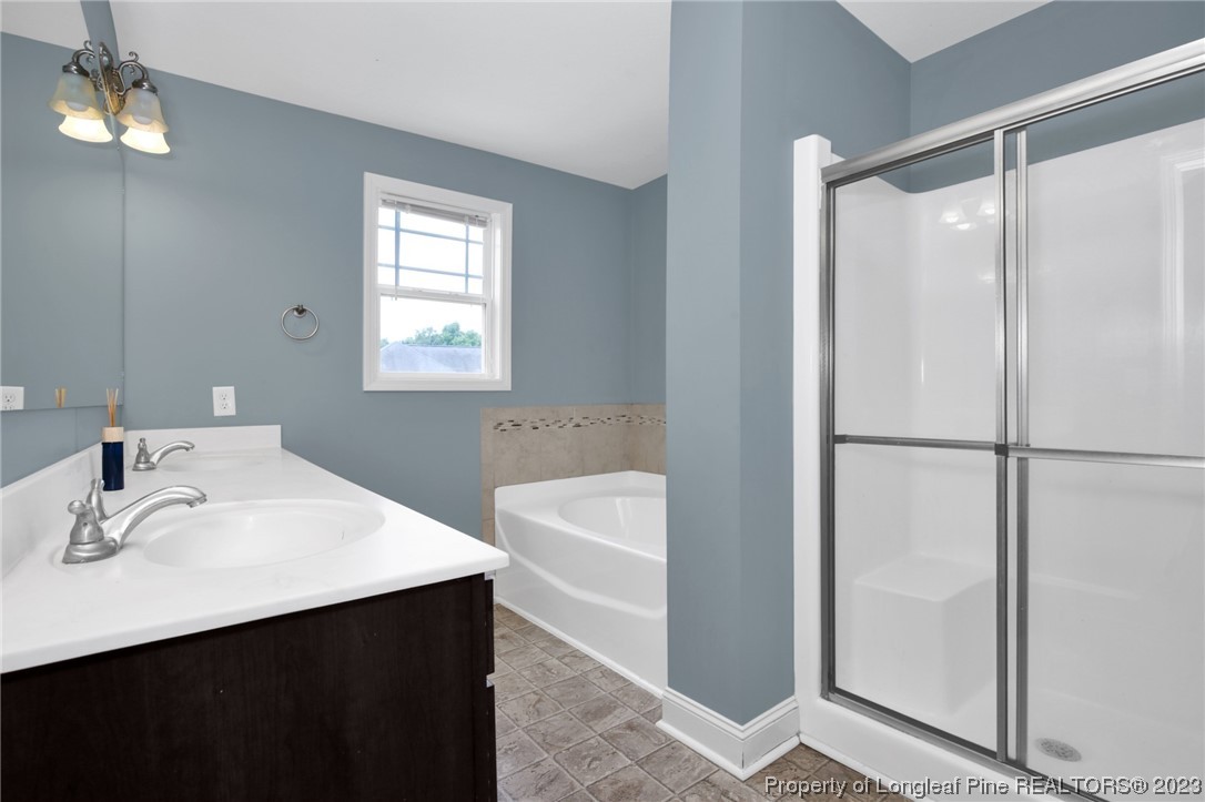 159 Boswell Street Raeford, NC 28376 - Photo 19 of 34 a bathroom with a sink a mirror and a shower