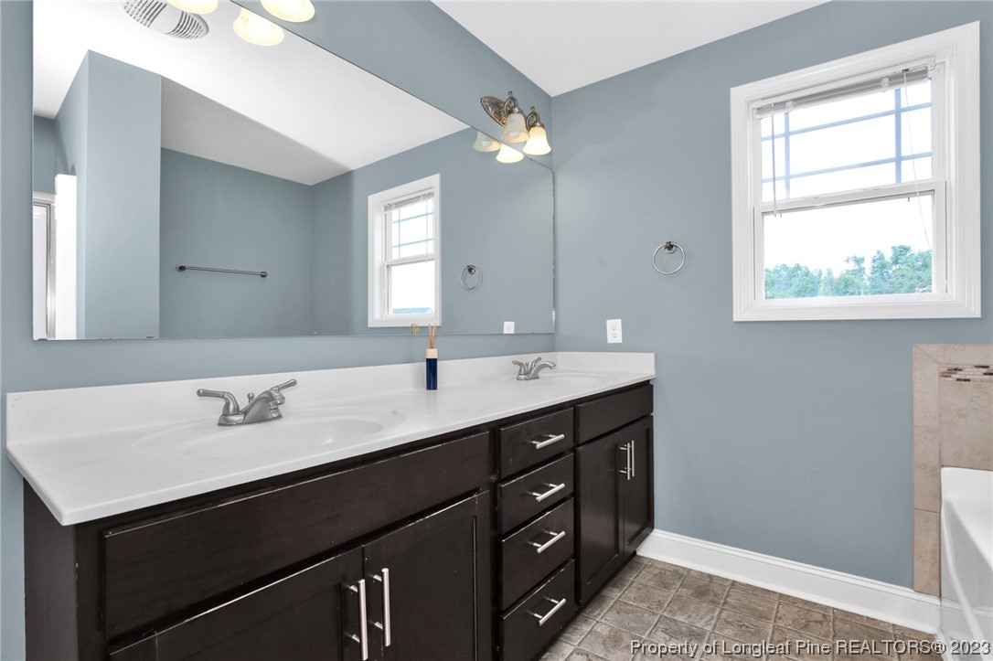 159 Boswell Street Raeford, NC 28376 - Photo 20 of 34 a bathroom with a sink double vanity and a mirror