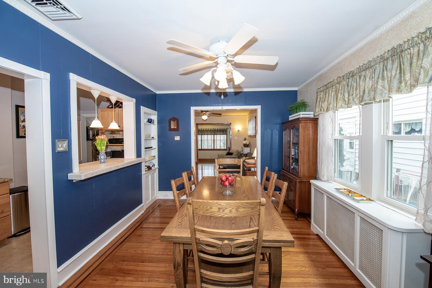 560 Wales Road Havertown, PA 19083 - Photo 16 of 69 a dining room with wooden floor a chandelier fan a livingroom and windows