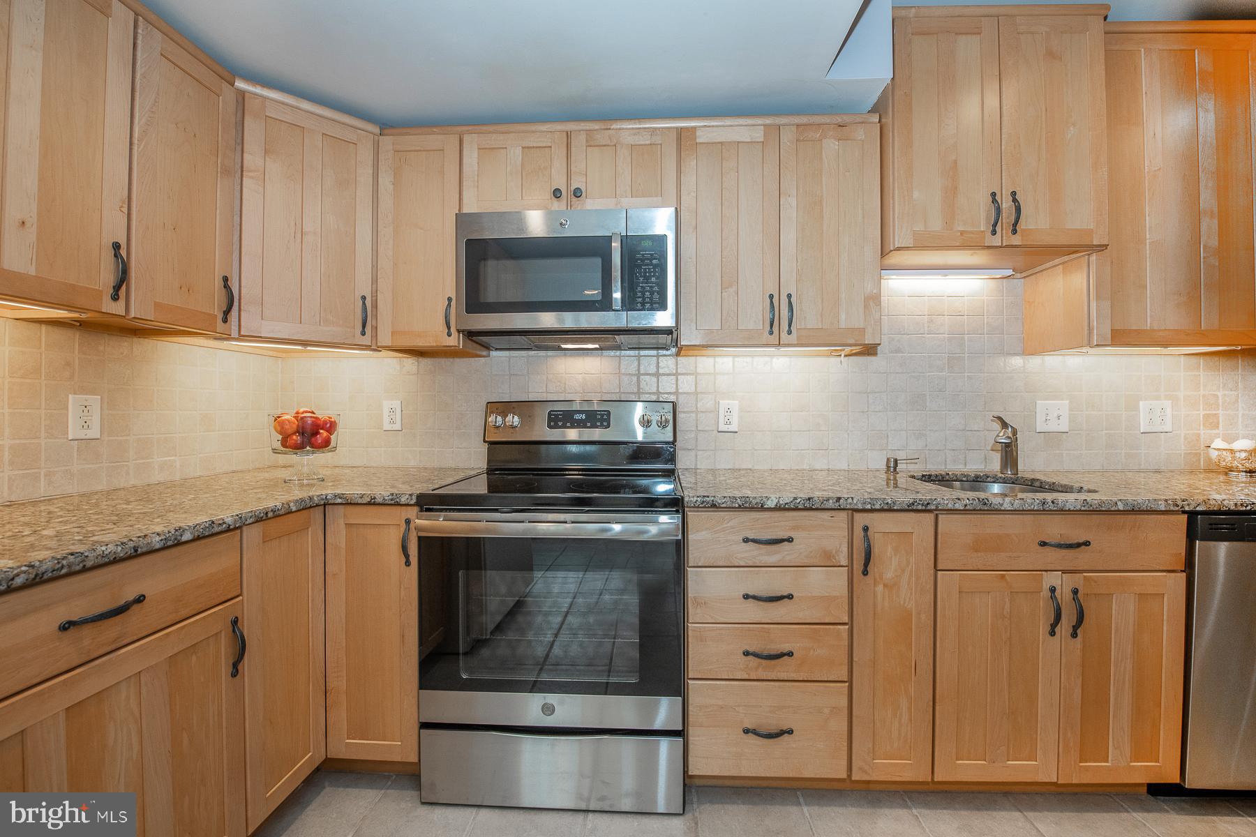560 Wales Road Havertown, PA 19083 - Photo 24 of 69 a kitchen with granite countertop white cabinets stainless steel appliances and sink