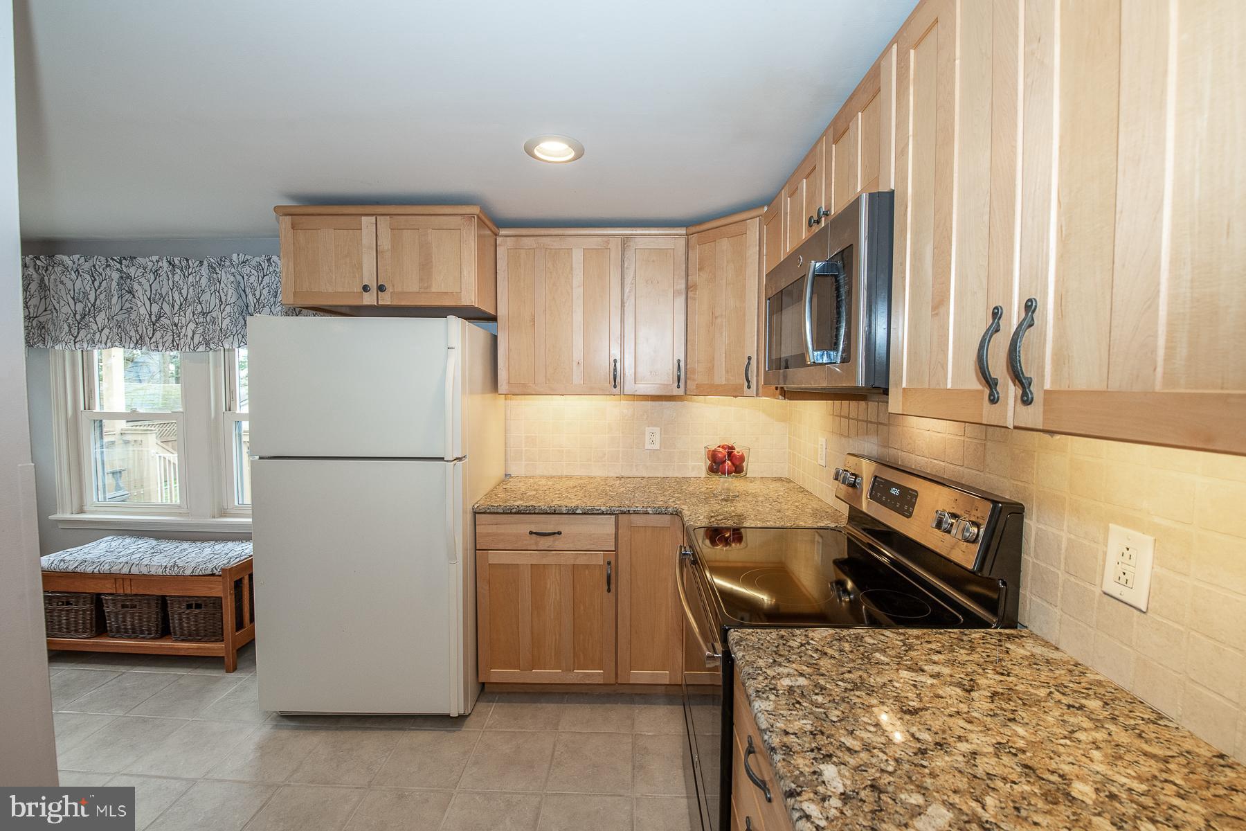 560 Wales Road Havertown, PA 19083 - Photo 26 of 69 a kitchen with a refrigerator a stove top oven and a large window