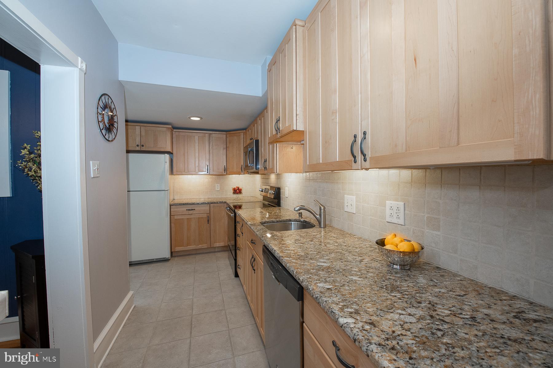 560 Wales Road Havertown, PA 19083 - Photo 28 of 69 a kitchen with stainless steel appliances granite countertop a sink stove and refrigerator