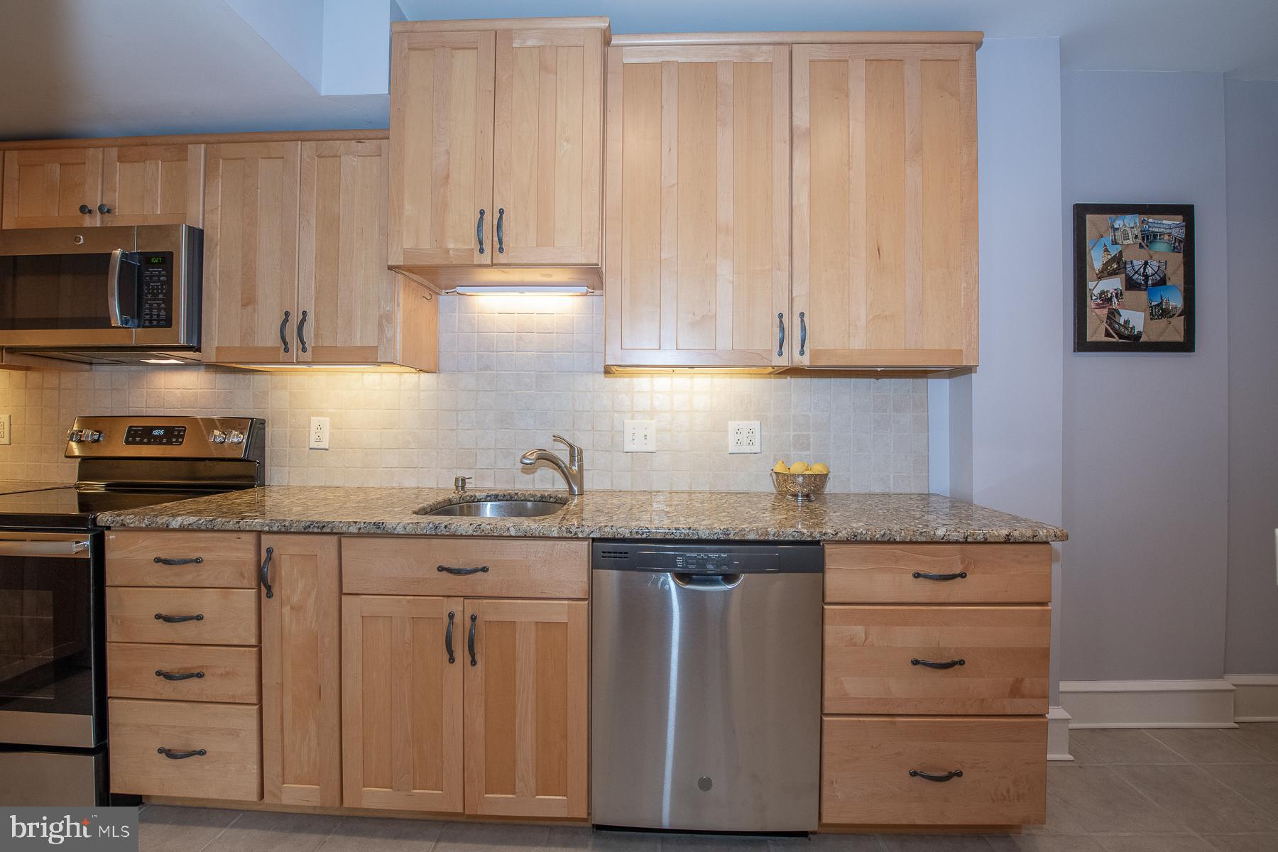 560 Wales Road Havertown, PA 19083 - Photo 31 of 69 a kitchen with granite countertop white cabinets and stainless steel appliances