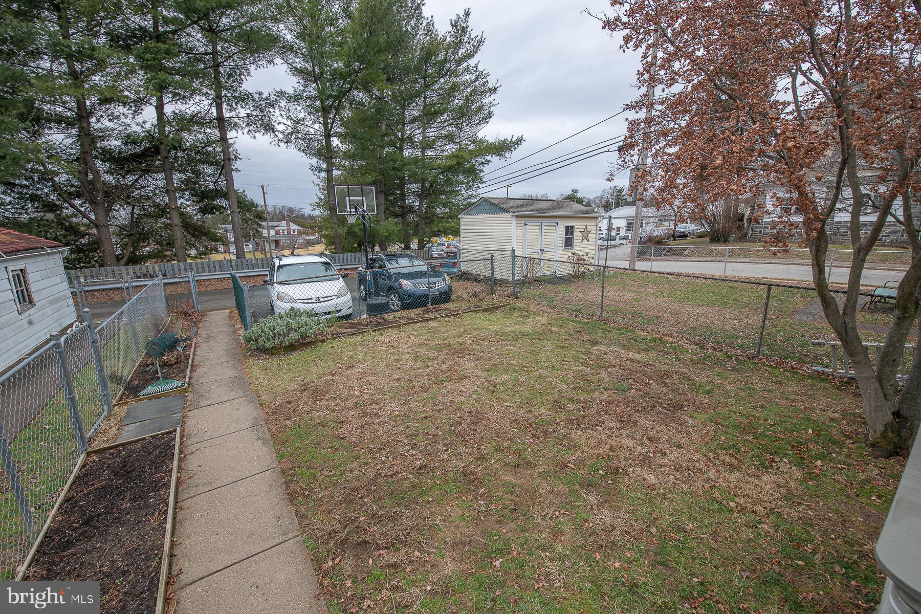 560 Wales Road Havertown, PA 19083 - Photo 64 of 69 a view of a patio with table and chairs under an umbrella