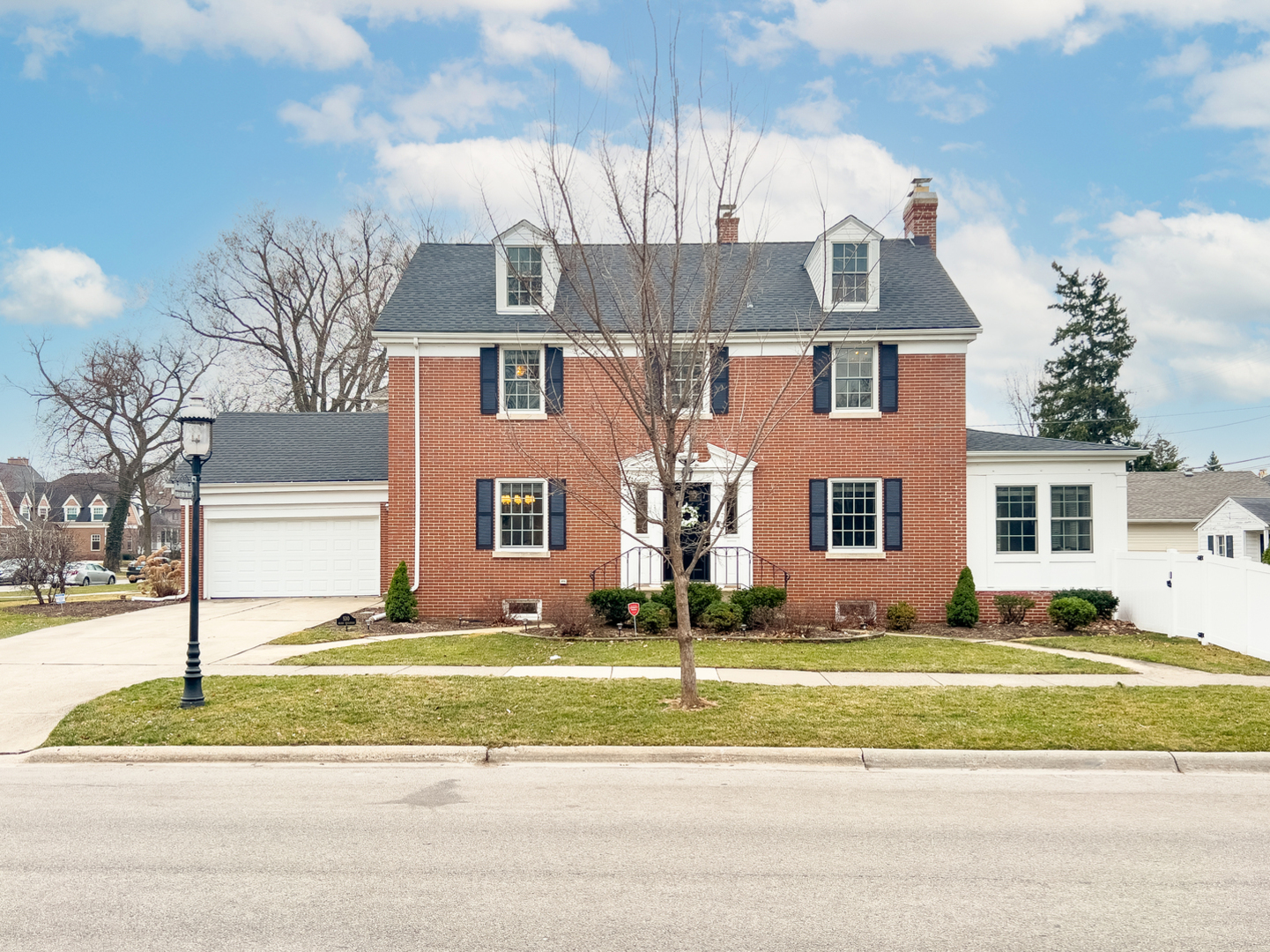 a view of a brick house next to a yard
