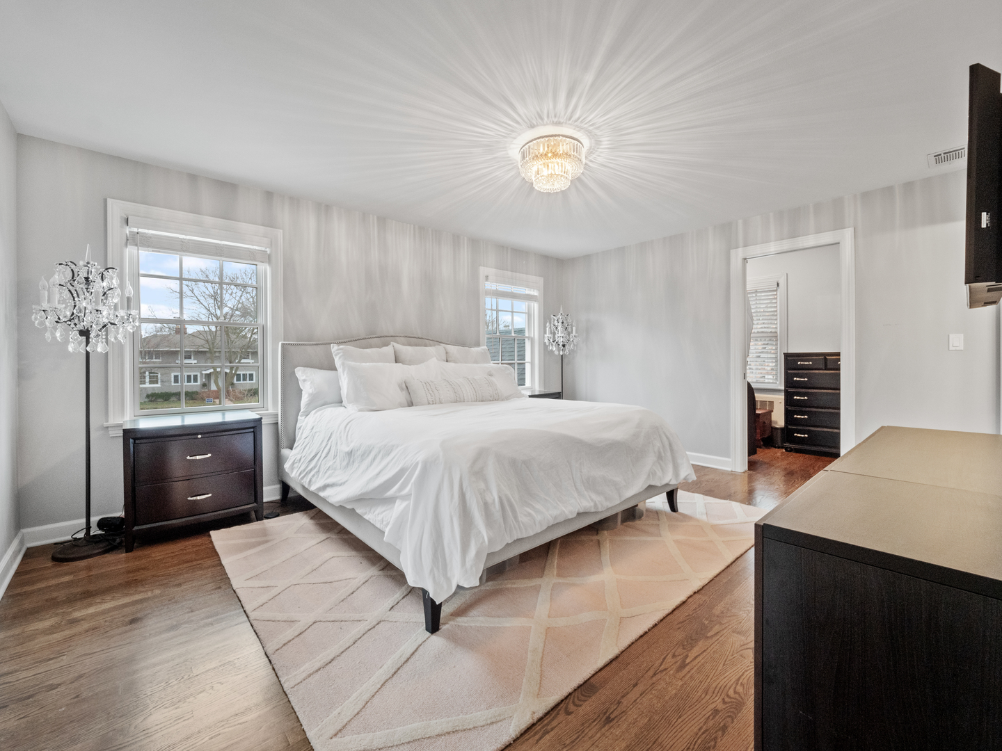 530 Grand Boulevard Park Ridge, IL 60068 - Photo 24 of 55 a bedroom with a large bed and a chandelier