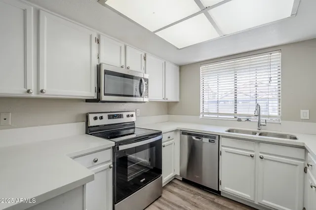 a kitchen with a sink stove and microwave