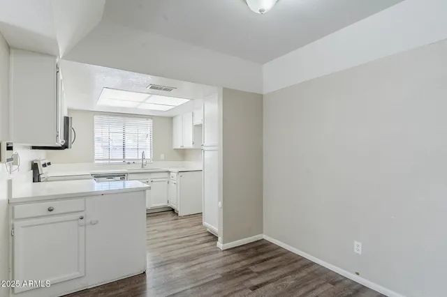 a bathroom with a sink mirror and a toilet