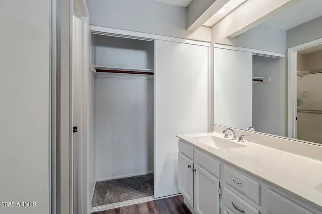 a bathroom with a double vanity sink and mirror