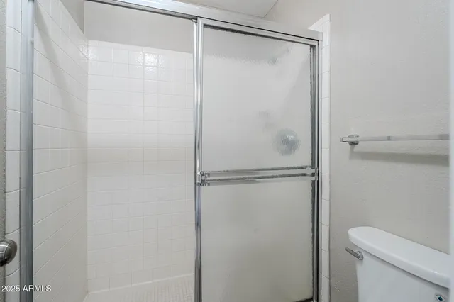 a bathroom with a glass shower door