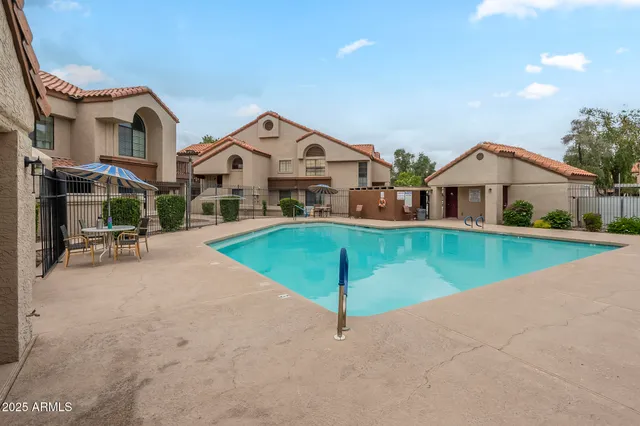 a view of a house with a yard and sitting area