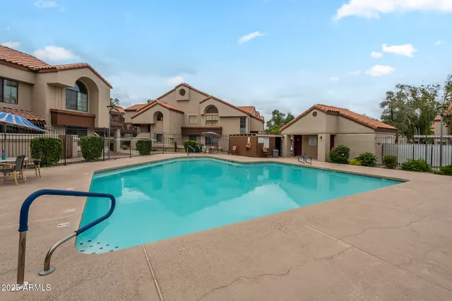 a view of a white house with a big yard and large trees