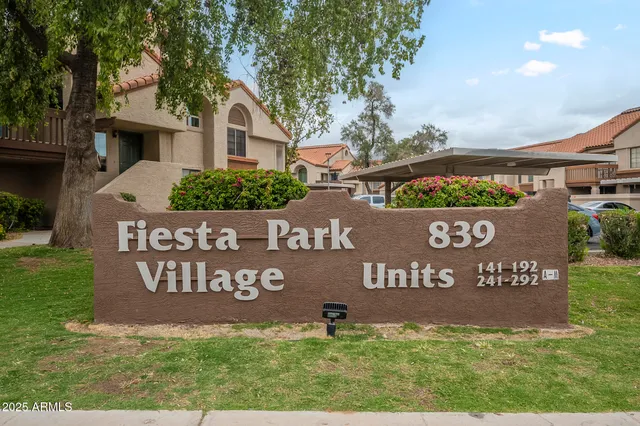 a view of outdoor space with a garden and signage