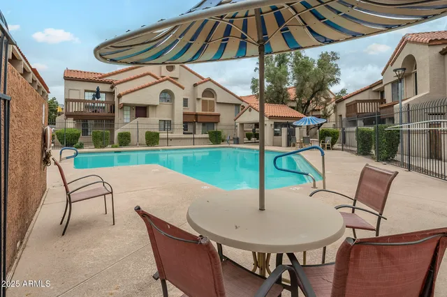a view of a house with a yard and furniture