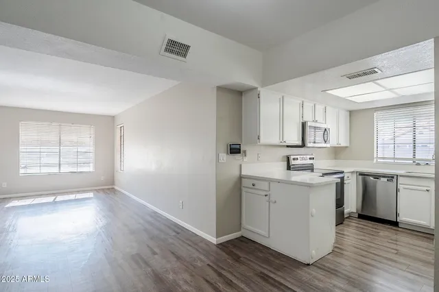 a kitchen with a sink stove and cabinets
