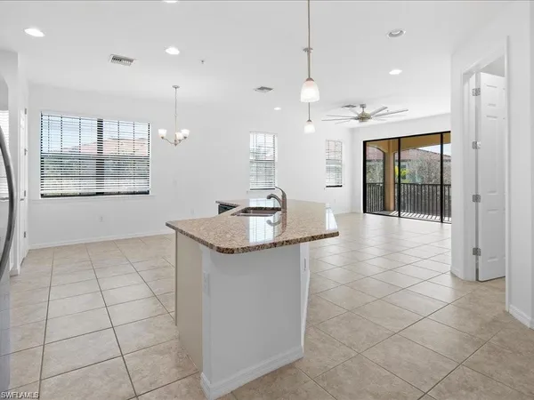 a kitchen with stainless steel appliances a sink stove and cabinets