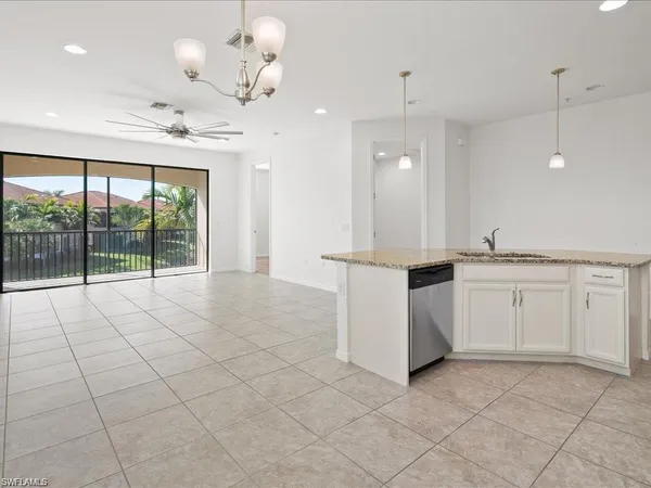 a view of a kitchen with a sink and chandelier