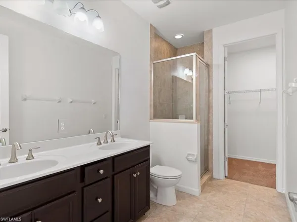 a bathroom with a toilet sink double and mirror