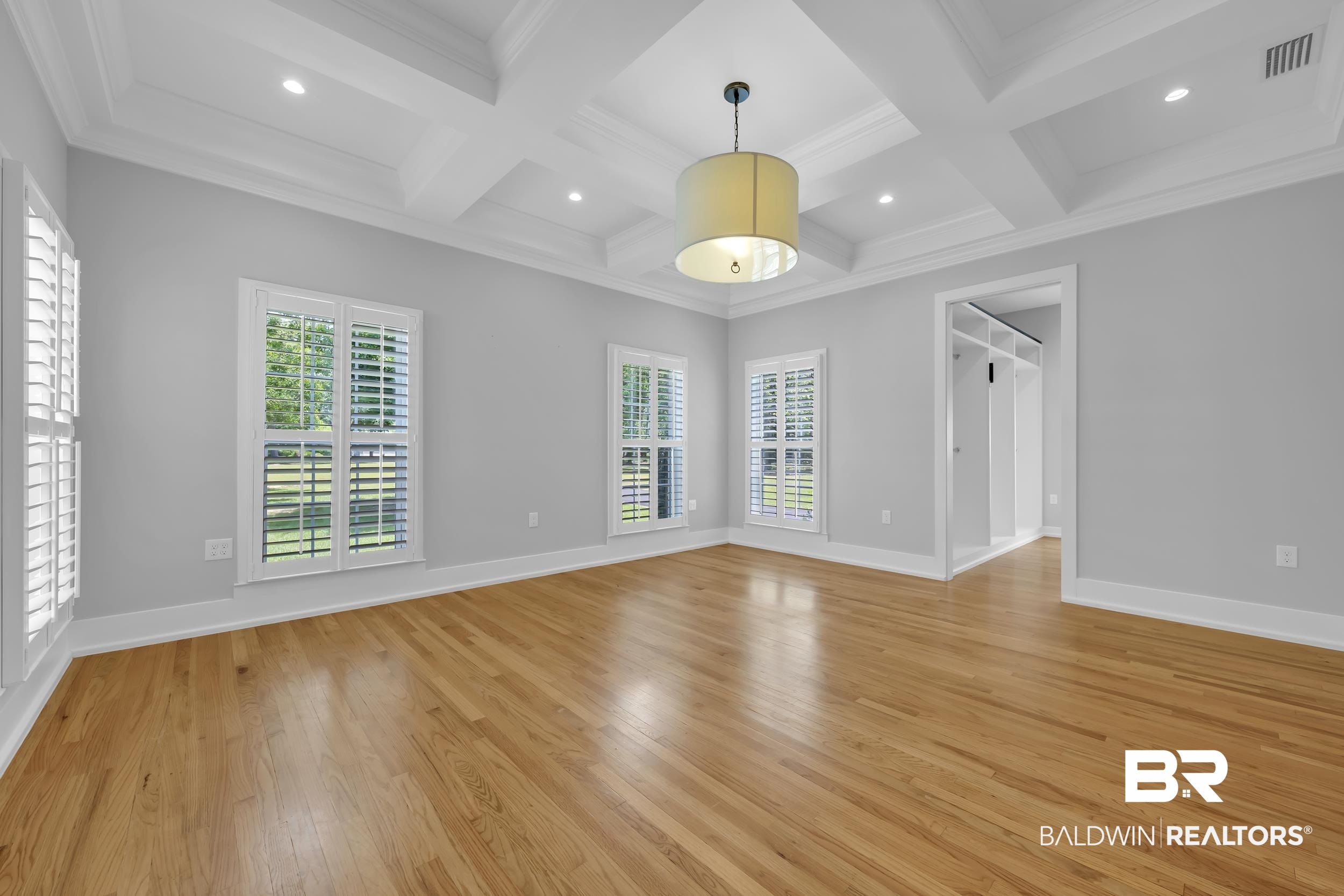 43199 Pine Grove Road Bay Minette, AL 36507 - Photo 44 of 71 Spacious room featuring wood-finish flooring, a coffered ceiling with recessed lighting, and a drum-style pendant fixture