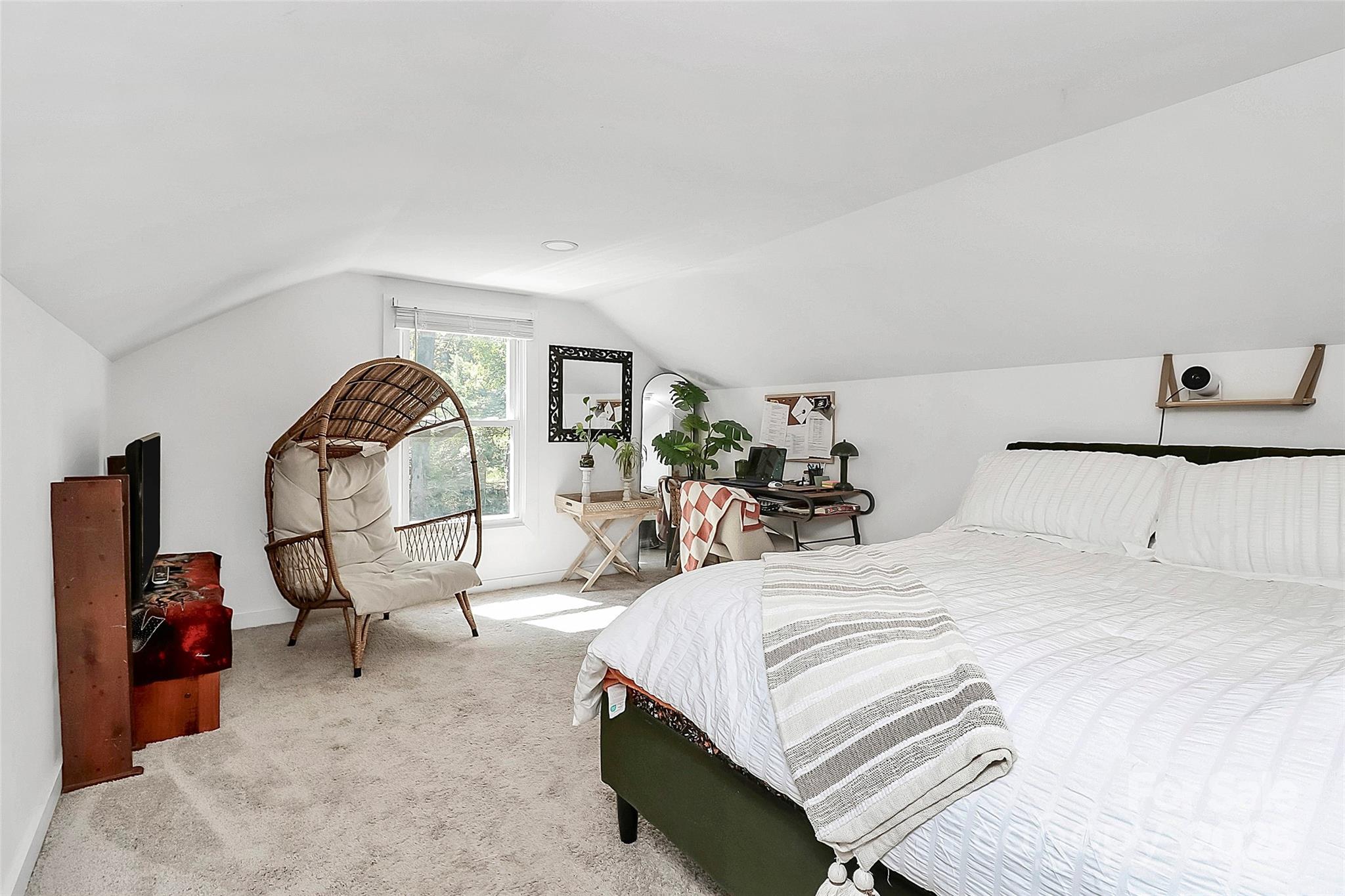 205 Mason Street Belmont, NC 28012 - Photo 15 of 27 a bed room with a bed a mirror and a lamp on dresser