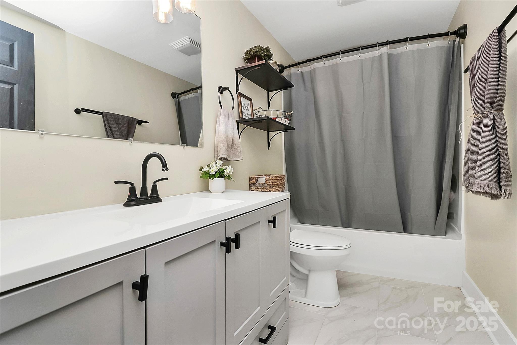 205 Mason Street Belmont, NC 28012 - Photo 18 of 27 a bathroom with a sink a toilet and shower