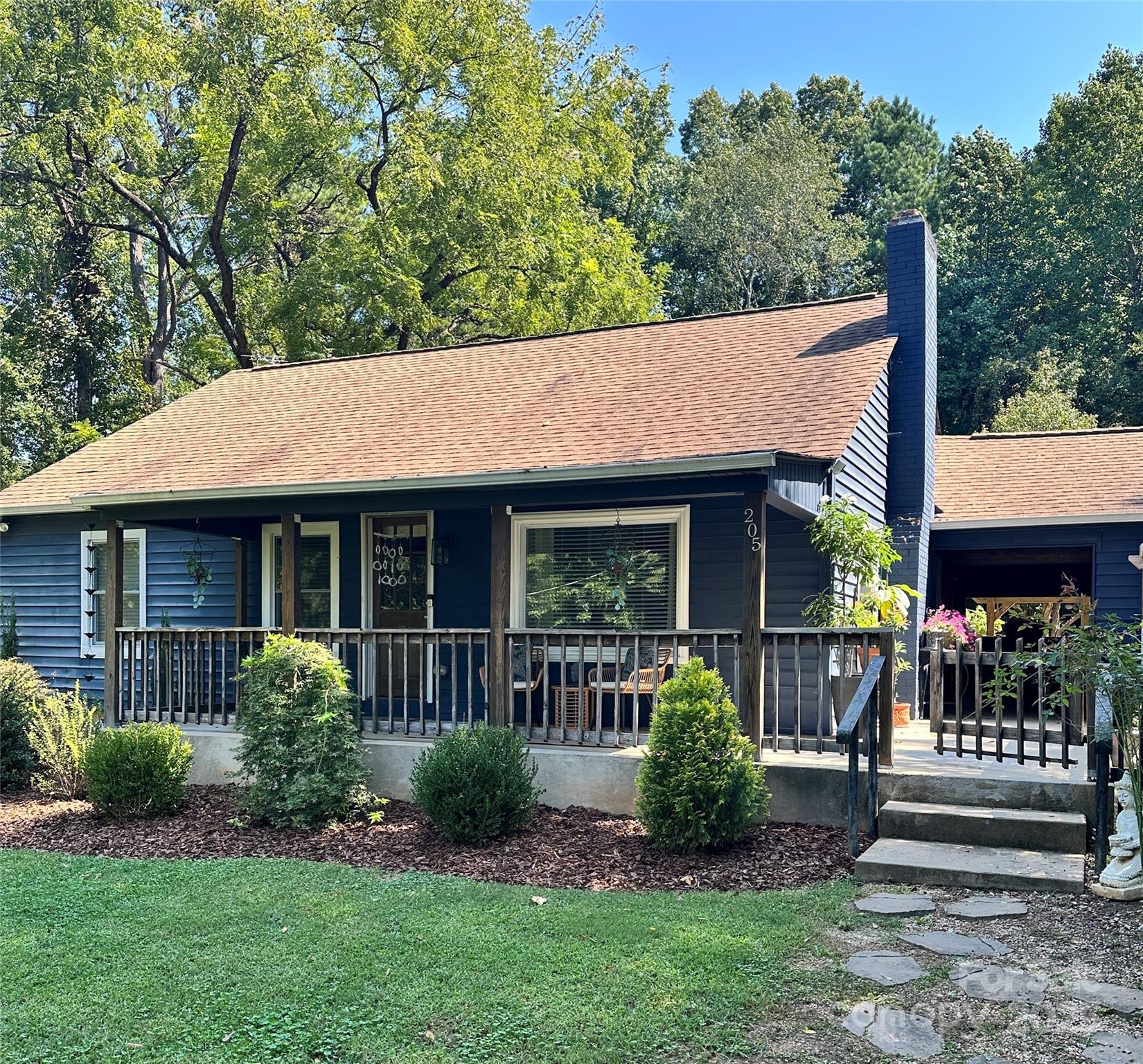 205 Mason Street Belmont, NC 28012 - Photo 2 of 27 a front view of a house with a yard table and chairs