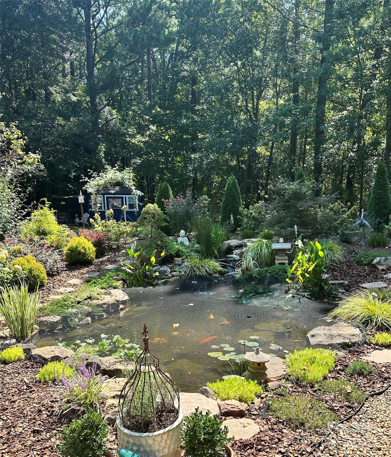 205 Mason Street Belmont, NC 28012 - Photo 22 of 27 a bunch of flowers and trees in a garden