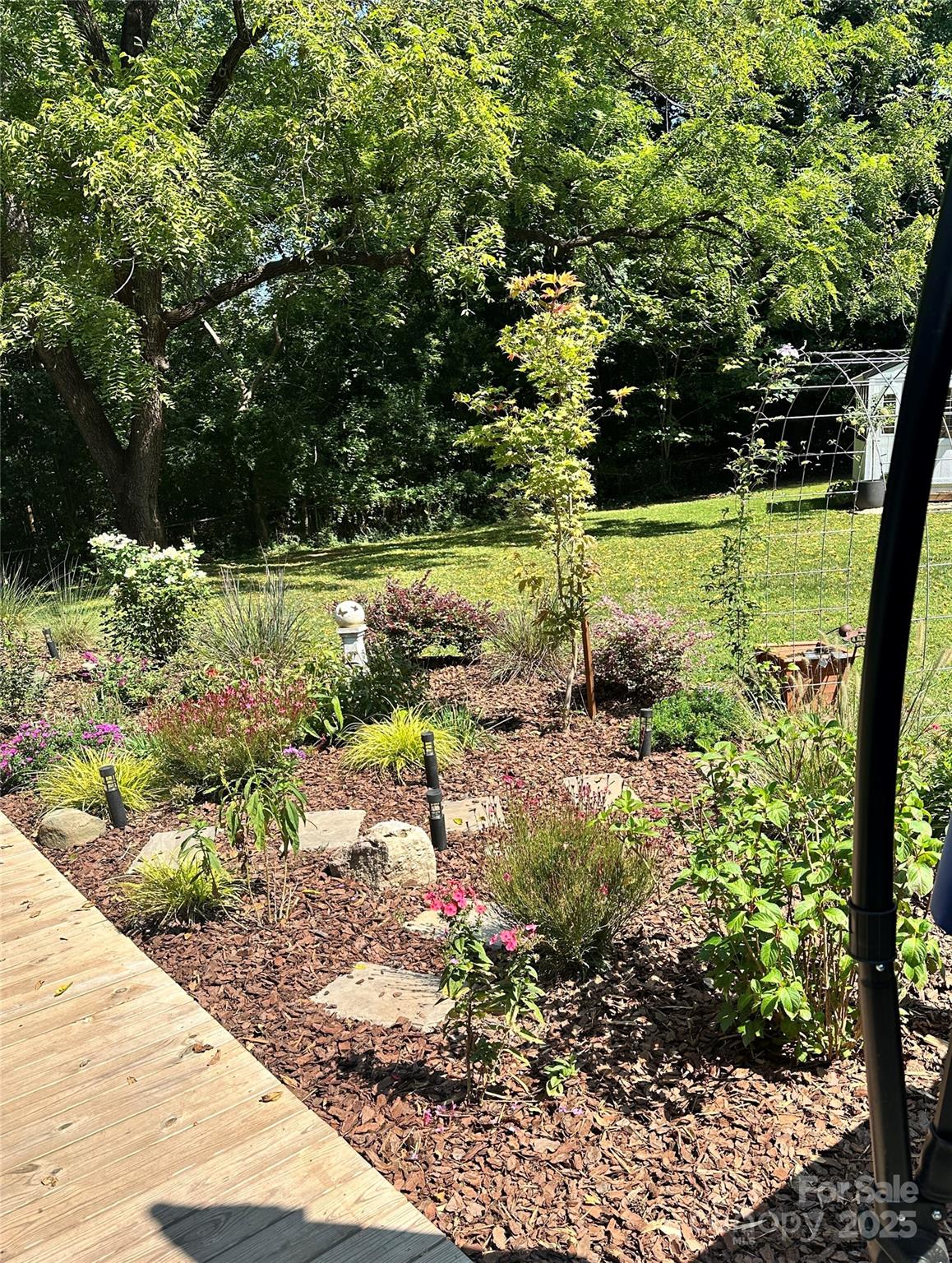 205 Mason Street Belmont, NC 28012 - Photo 23 of 27 a view of a garden with large trees
