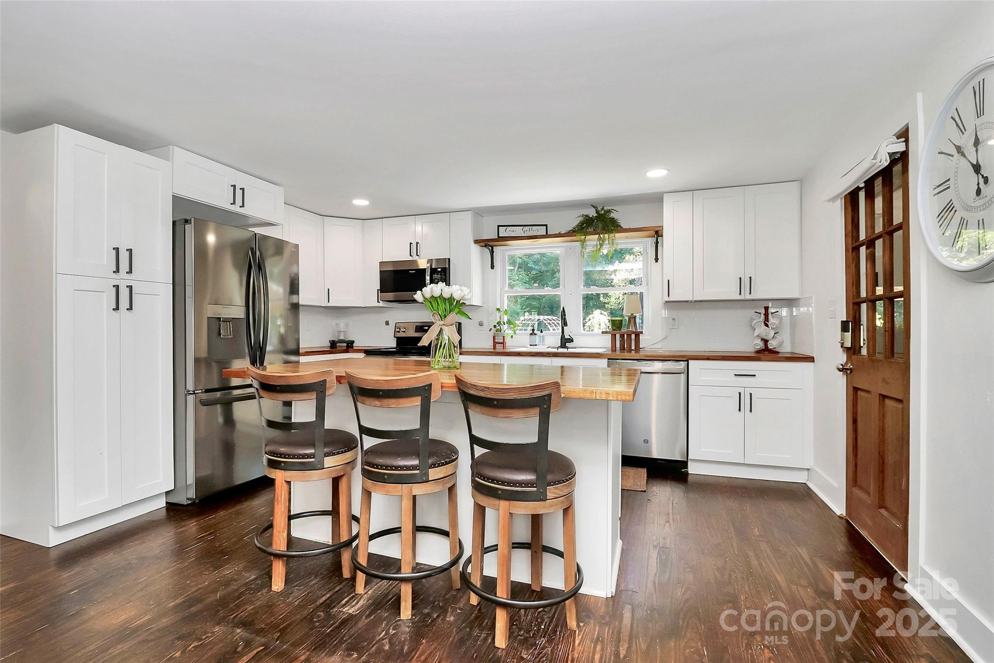 205 Mason Street Belmont, NC 28012 - Photo 6 of 27 a kitchen with a table chairs refrigerator and cabinets