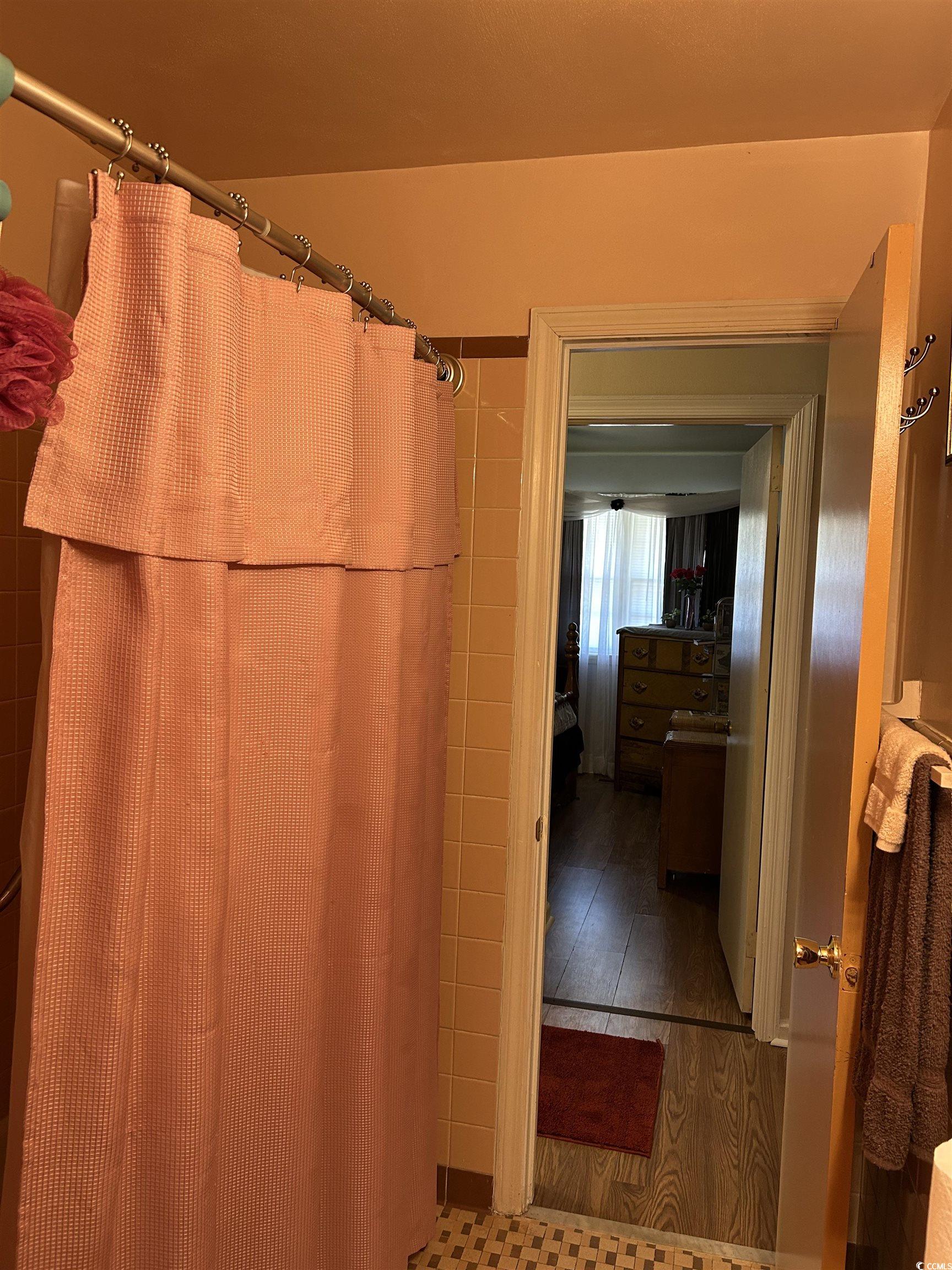 1411 East Harrison Street Dillon, SC 29536 - Photo 29 of 40 Bathroom with wood finished floors, a shower with shower curtain, and vanity