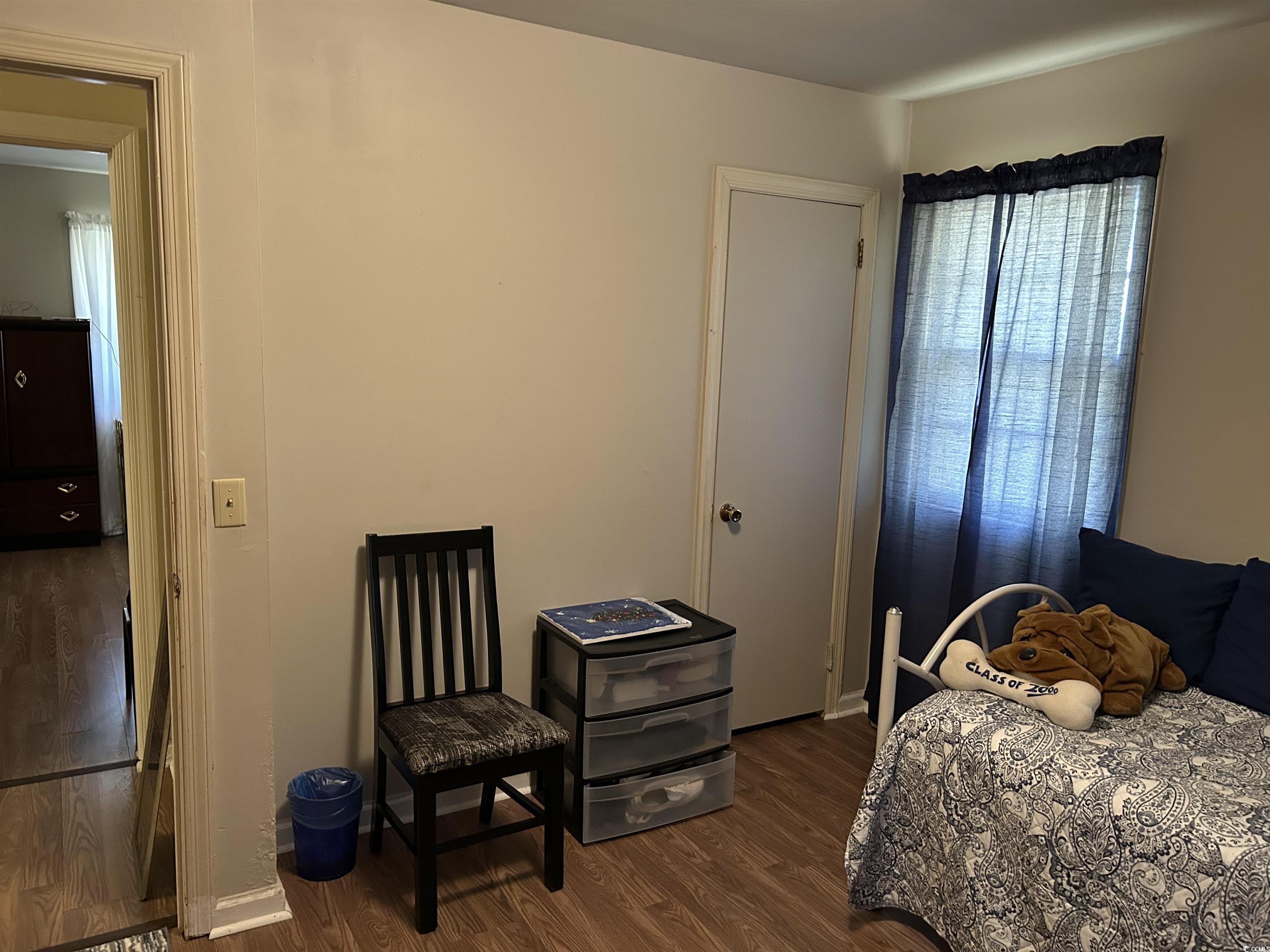 1411 East Harrison Street Dillon, SC 29536 - Photo 36 of 40 Bedroom with dark wood-style flooring and baseboards