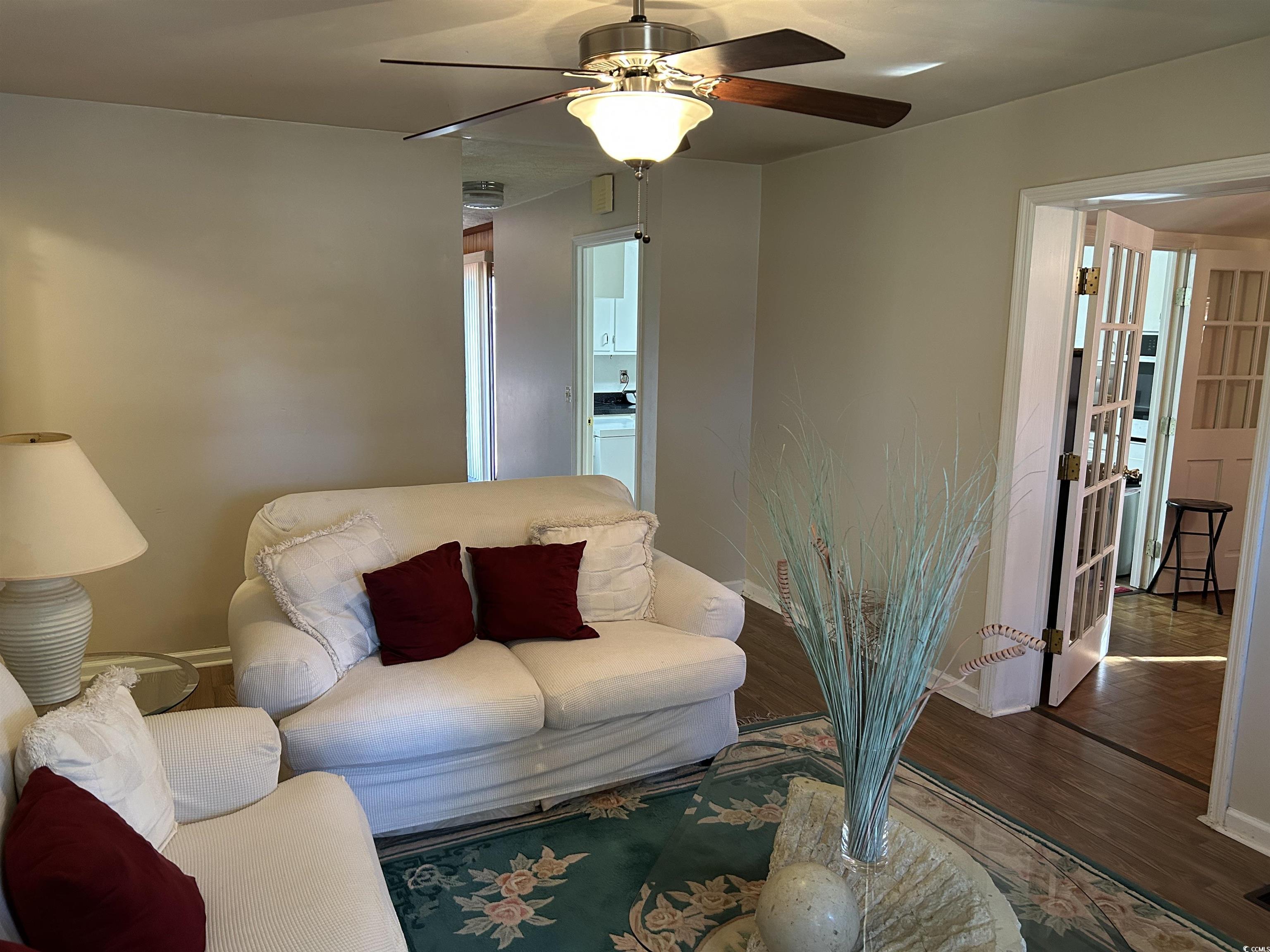 1411 East Harrison Street Dillon, SC 29536 - Photo 6 of 40 Living room featuring wood finished floors, a ceiling fan, and washer / clothes dryer