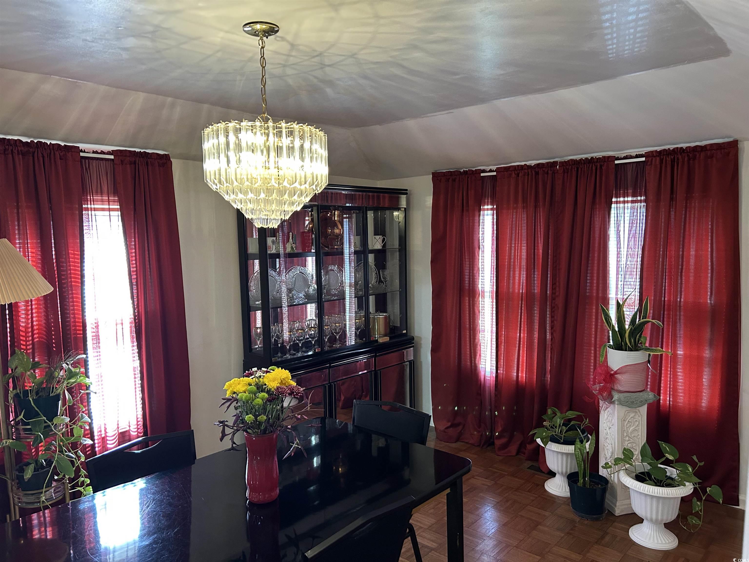 1411 East Harrison Street Dillon, SC 29536 - Photo 8 of 40 Dining space with a chandelier, healthy amount of natural light, and lofted ceiling