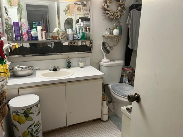 14036 Southwest 90th Avenue, Unit 103AA Miami, FL 33176 - Photo 12 of 13 a bathroom with a sink mirror and toilet