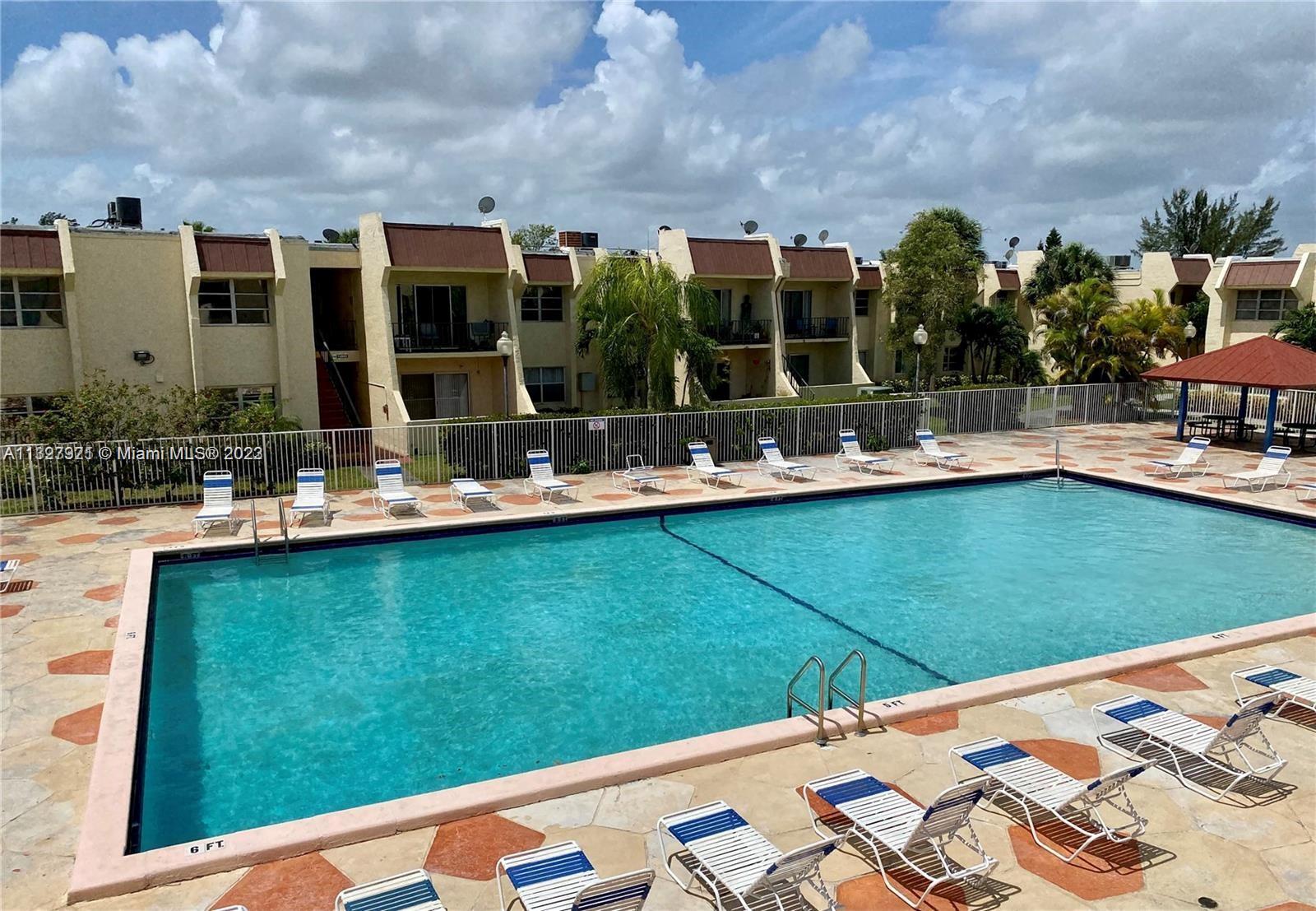 14036 Southwest 90th Avenue, Unit 103AA Miami, FL 33176 - Photo 4 of 13 a view of swimming pool with outdoor seating and barbeque oven