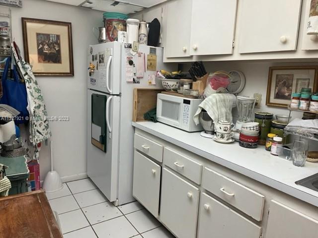 14036 Southwest 90th Avenue, Unit 103AA Miami, FL 33176 - Photo 9 of 13 a kitchen with stainless steel appliances a refrigerator and cabinets