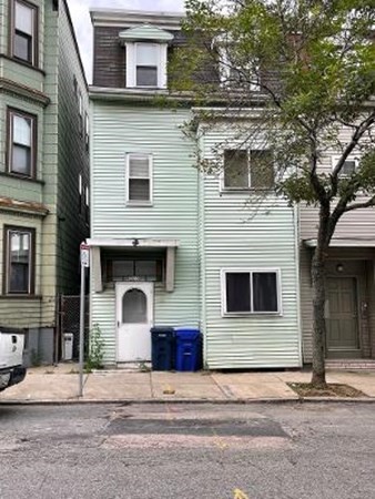 203 Lexington Street Boston, MA 02128 - Photo 1 of 24 a front view of a house with garage