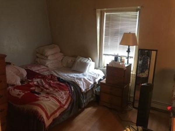 203 Lexington Street Boston, MA 02128 - Photo 12 of 24 a bedroom with a bed and a lamp