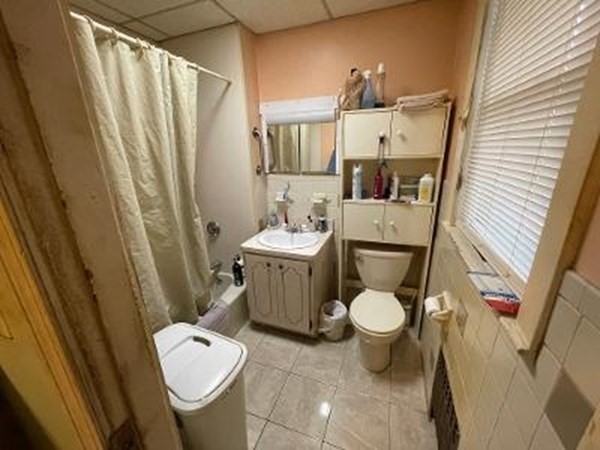 203 Lexington Street Boston, MA 02128 - Photo 14 of 24 a bathroom with a sink toilet and shower