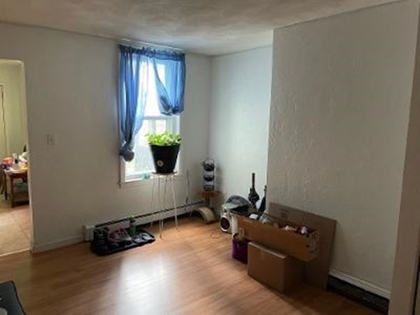 203 Lexington Street Boston, MA 02128 - Photo 8 of 24 a room with furniture and window