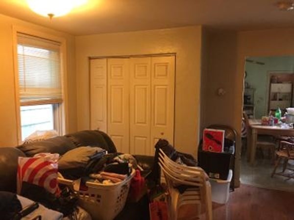 203 Lexington Street Boston, MA 02128 - Photo 9 of 24 a bedroom with a bed and a window